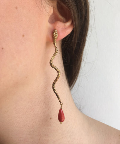 gold snake earrings with coral pearls worn