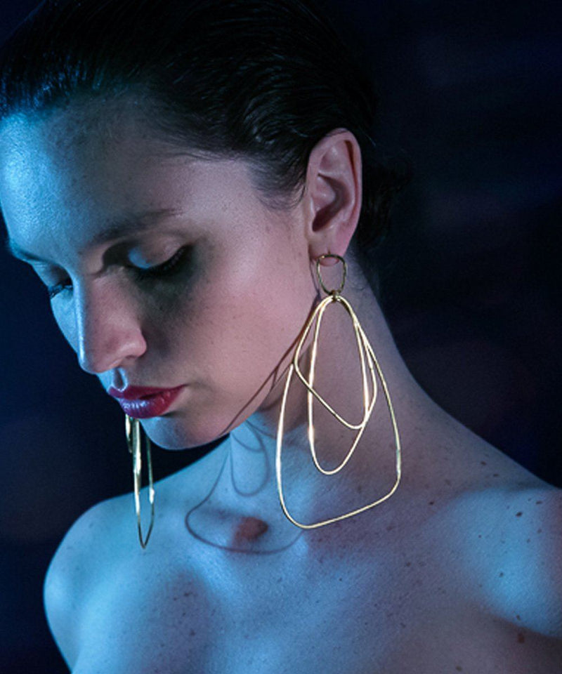 Giant golden earrings - "Here" designer Eloise Fiorentino